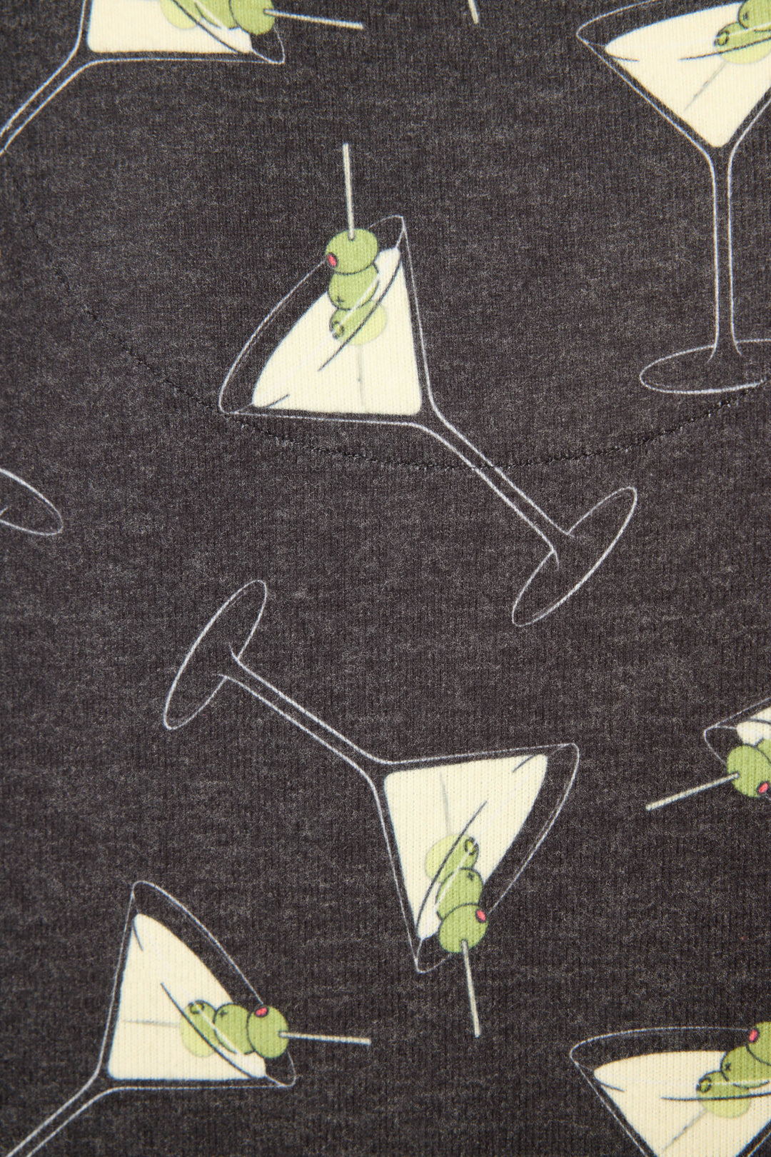 The Merrier With A Martini Long Sleeve Top by P.J. Salvage features dark fabric with a repeating pattern of martini glasses, each filled with a yellowish liquid and green olives, oriented in various directions.