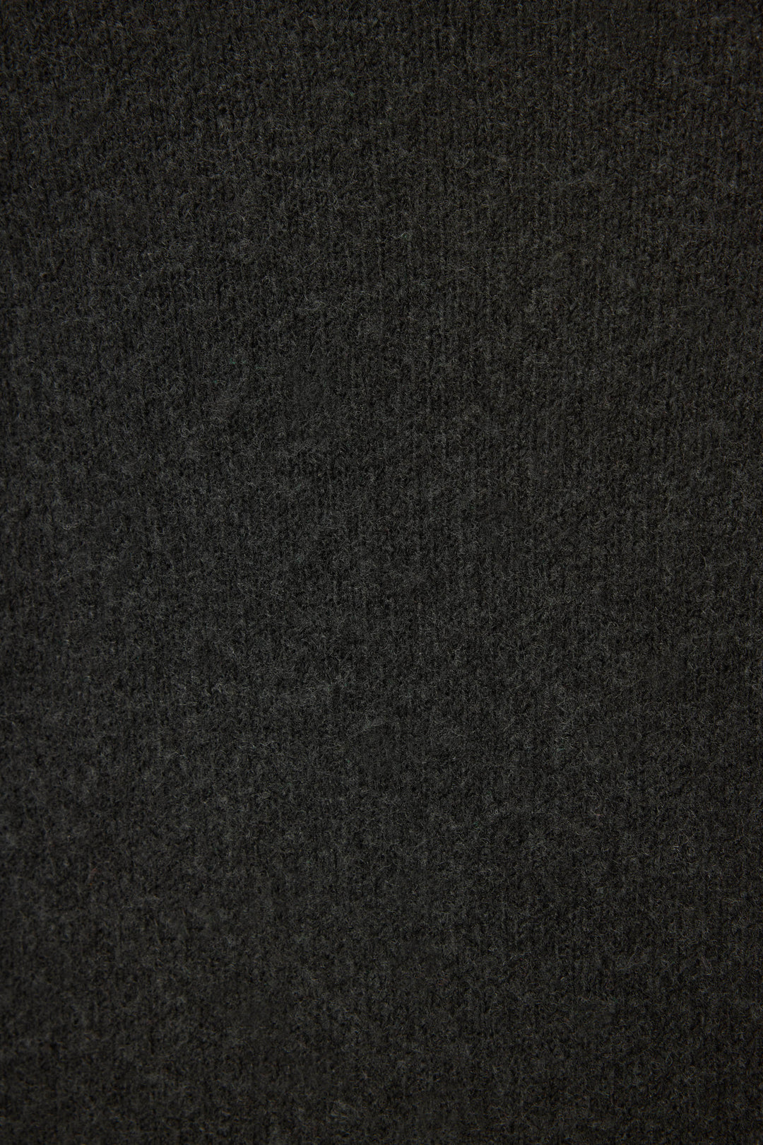 Close-up of the Merrier With A Martini Snuggle Sweater by P.J. Salvage, featuring dark gray, soft textured fabric with a subtle knit pattern. The surface appears slightly fuzzy and uniform with no visible seams.