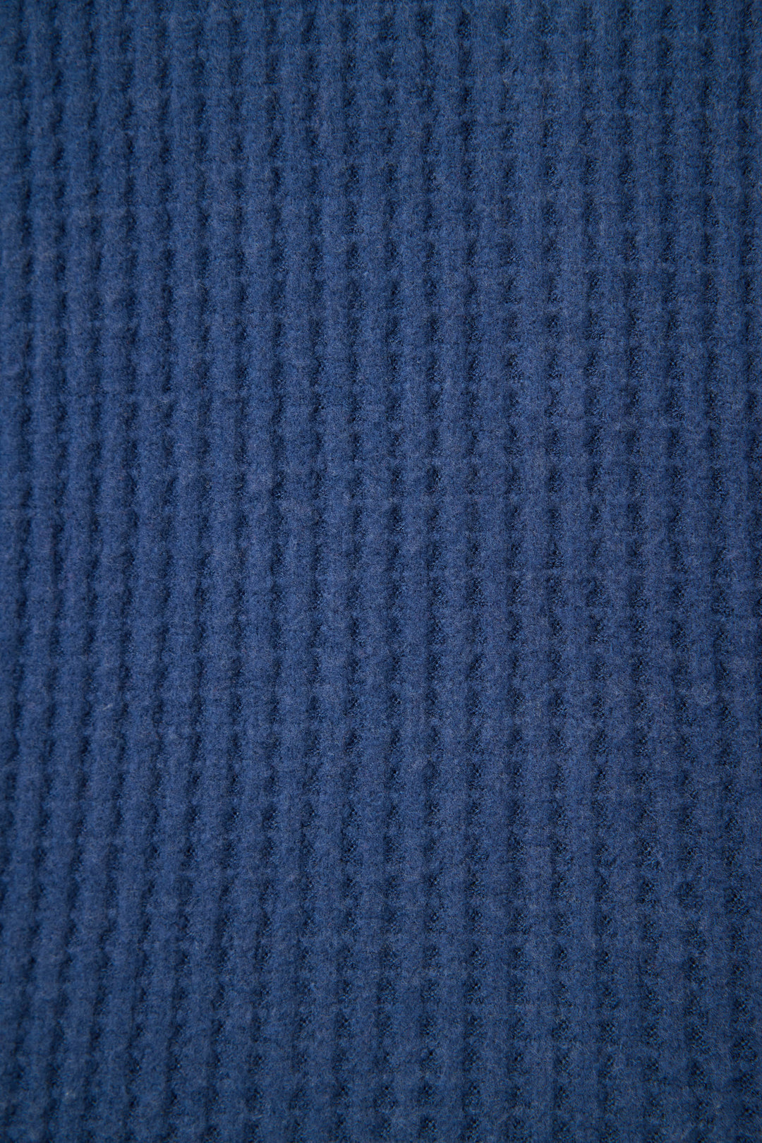 Close-up of the Morning Waffles Solid Navy Long Sleeve Top by P.J. Salvage, showing its soft, slightly fuzzy blue ribbed fabric with a vertical textured pattern.