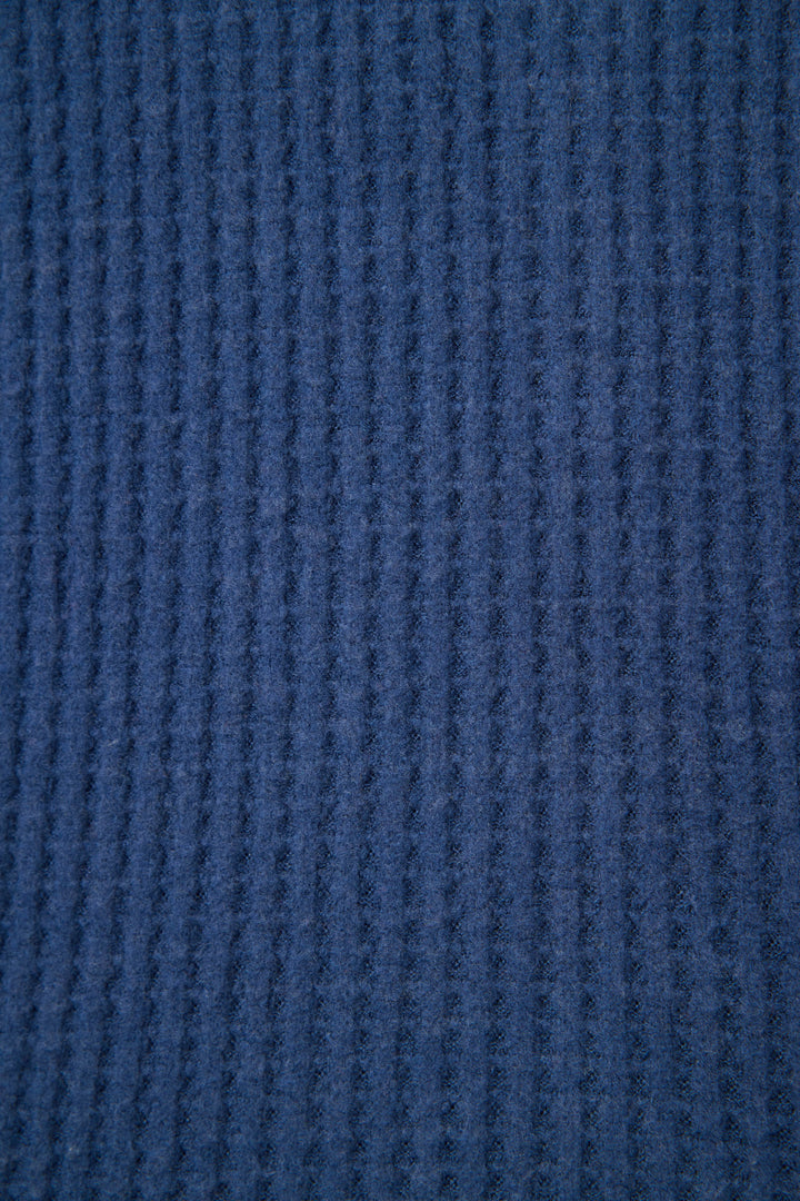 Close-up of the Morning Waffles Solid Navy Long Sleeve Top by P.J. Salvage, showing its soft, slightly fuzzy blue ribbed fabric with a vertical textured pattern.