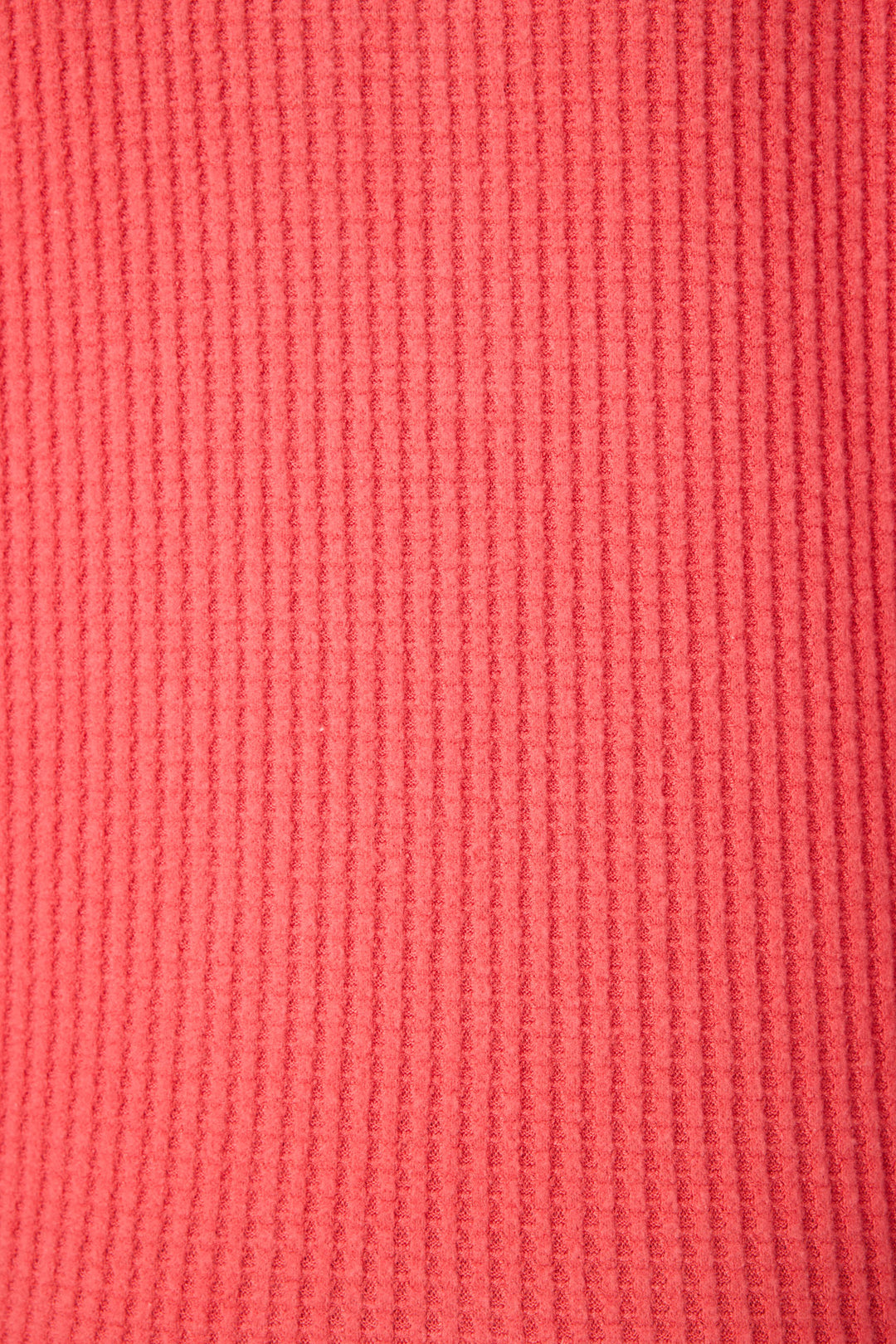 Close-up of the textured, ribbed fabric in bright scarlet pink from the P.J. Salvage Morning Waffles Scarlet Long Sleeve Top, featuring evenly spaced vertical ridges throughout.