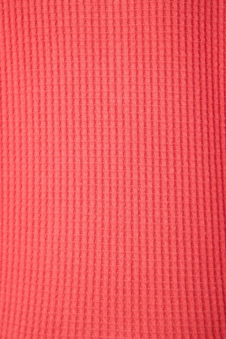 Close-up of the textured, ribbed fabric in bright scarlet pink from the P.J. Salvage Morning Waffles Scarlet Long Sleeve Top, featuring evenly spaced vertical ridges throughout.
