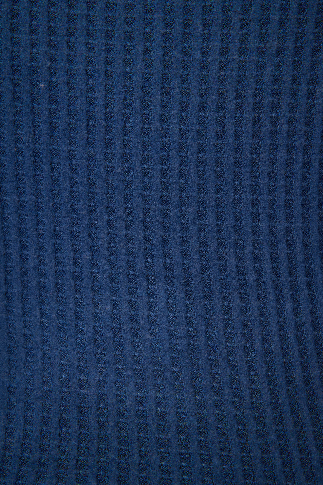 Close-up of the Morning Waffles Solid Navy Open Leg Pant by P.J. Salvage, featuring blue textured fabric with a soft feel and a repeating vertical ribbed pattern.