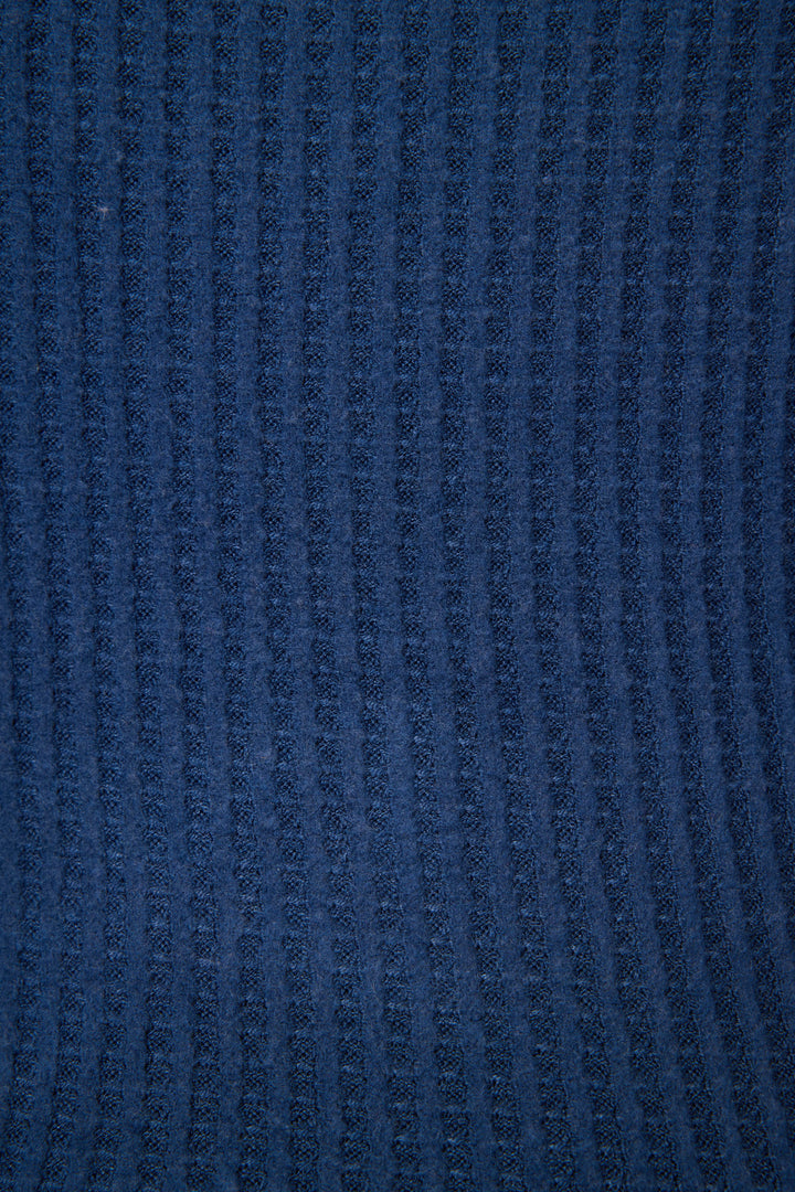 Close-up of the Morning Waffles Solid Navy Open Leg Pant by P.J. Salvage, featuring blue textured fabric with a soft feel and a repeating vertical ribbed pattern.