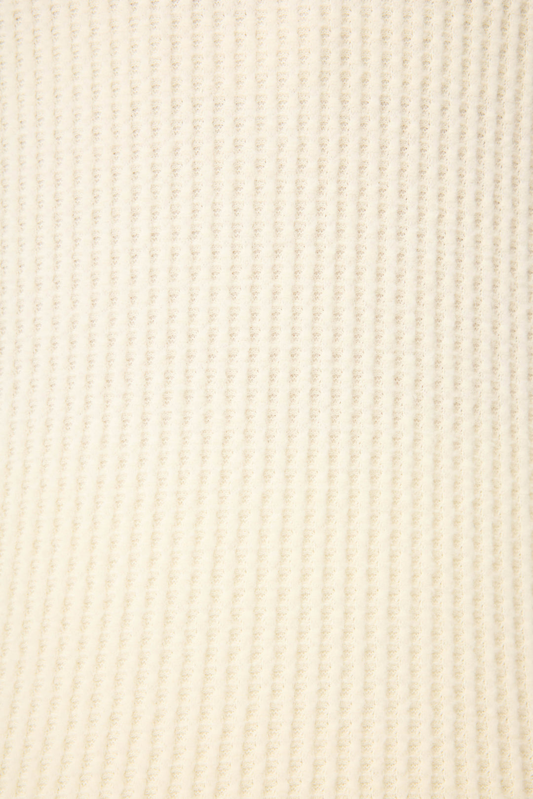 A close-up of the P.J. Salvage Morning Waffles Solid Ivory Open Leg Pant reveals a soft, light beige ribbed fabric with evenly spaced vertical ridges and a slightly fuzzy texture.