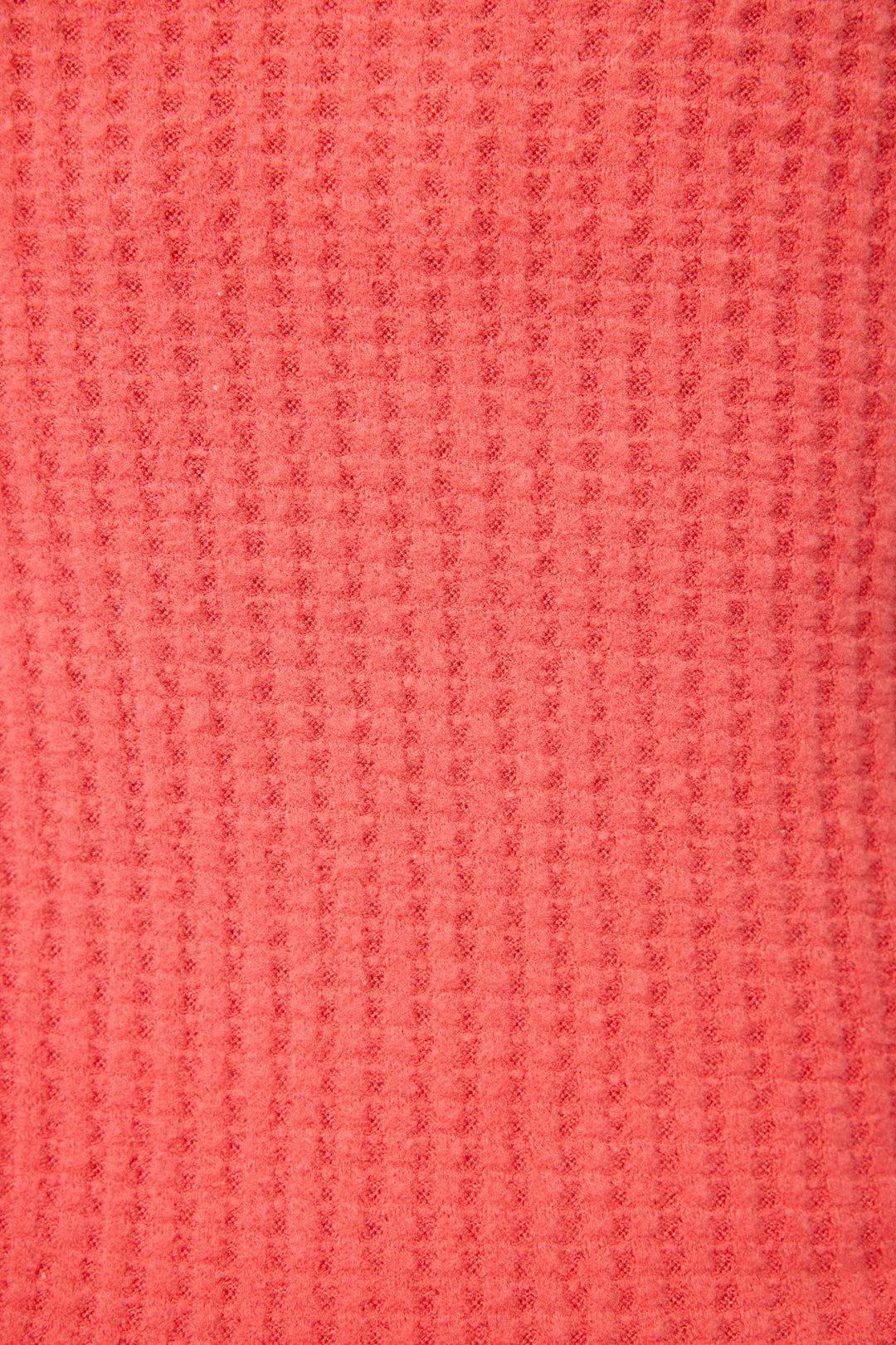 Close-up of the Morning Waffles Scarlet Open Leg Pant by P.J. Salvage, showing its textured coral waffle knit fabric with a pinkish-red hue and raised square honeycomb pattern.