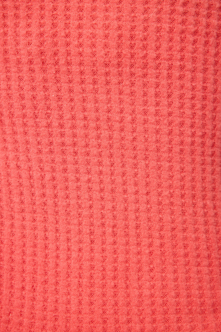 Close-up of the Morning Waffles Scarlet Open Leg Pant by P.J. Salvage, showing its textured coral waffle knit fabric with a pinkish-red hue and raised square honeycomb pattern.
