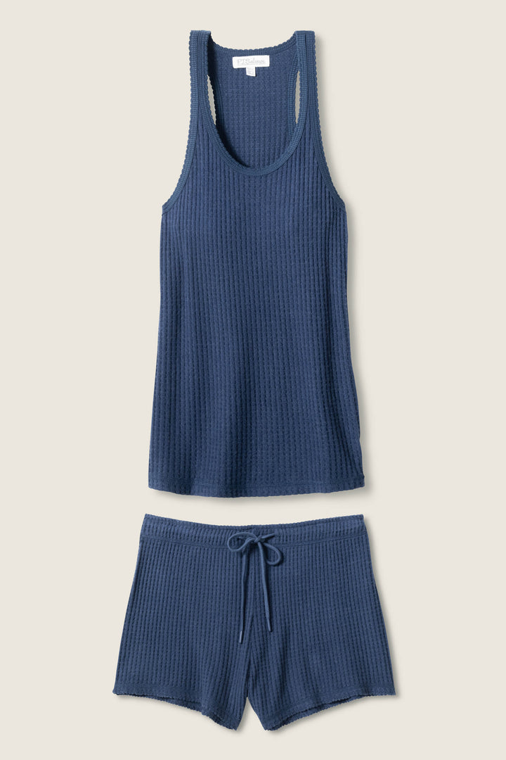 The P.J. Salvage Morning Waffles Harbor Loungewear Set—a blue waffle knit racerback tank and drawstring shorts—is displayed flat on a neutral background.