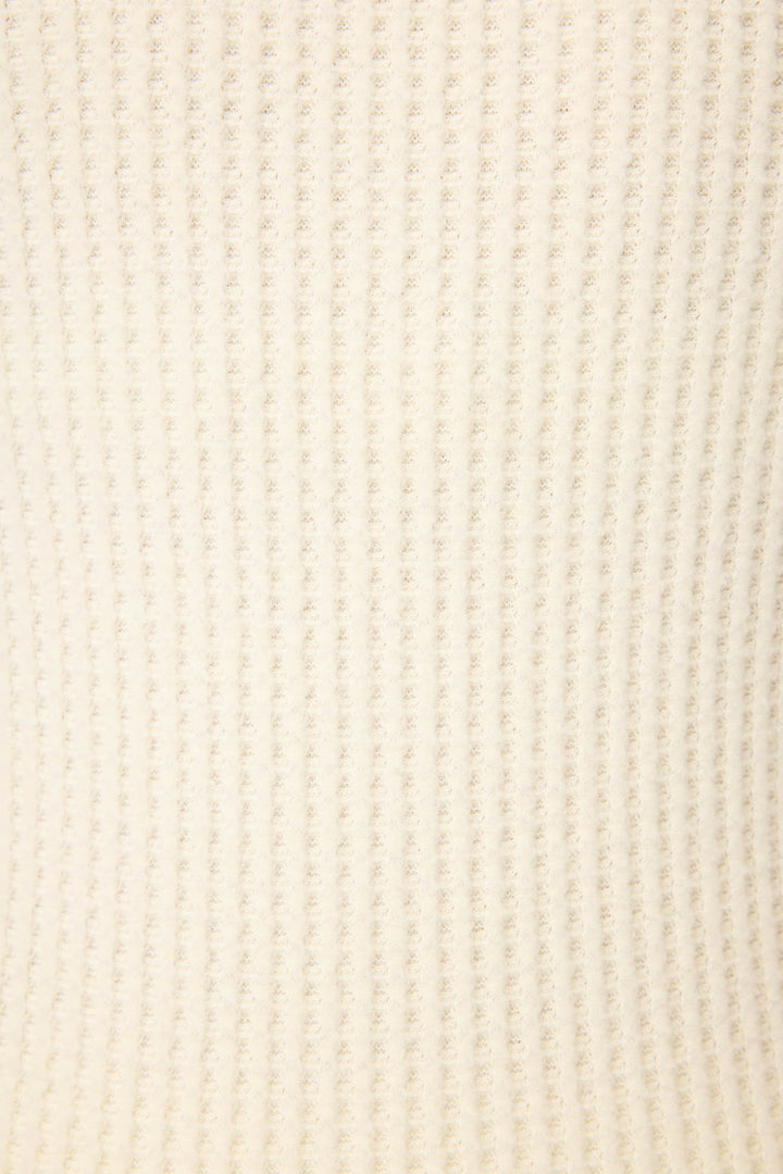 Close-up of the P.J. Salvage Morning Waffles Solid Ivory Loungewear Set, featuring a soft, cream-colored ribbed knit fabric with vertical ridges creating a cozy, repeating textured pattern.