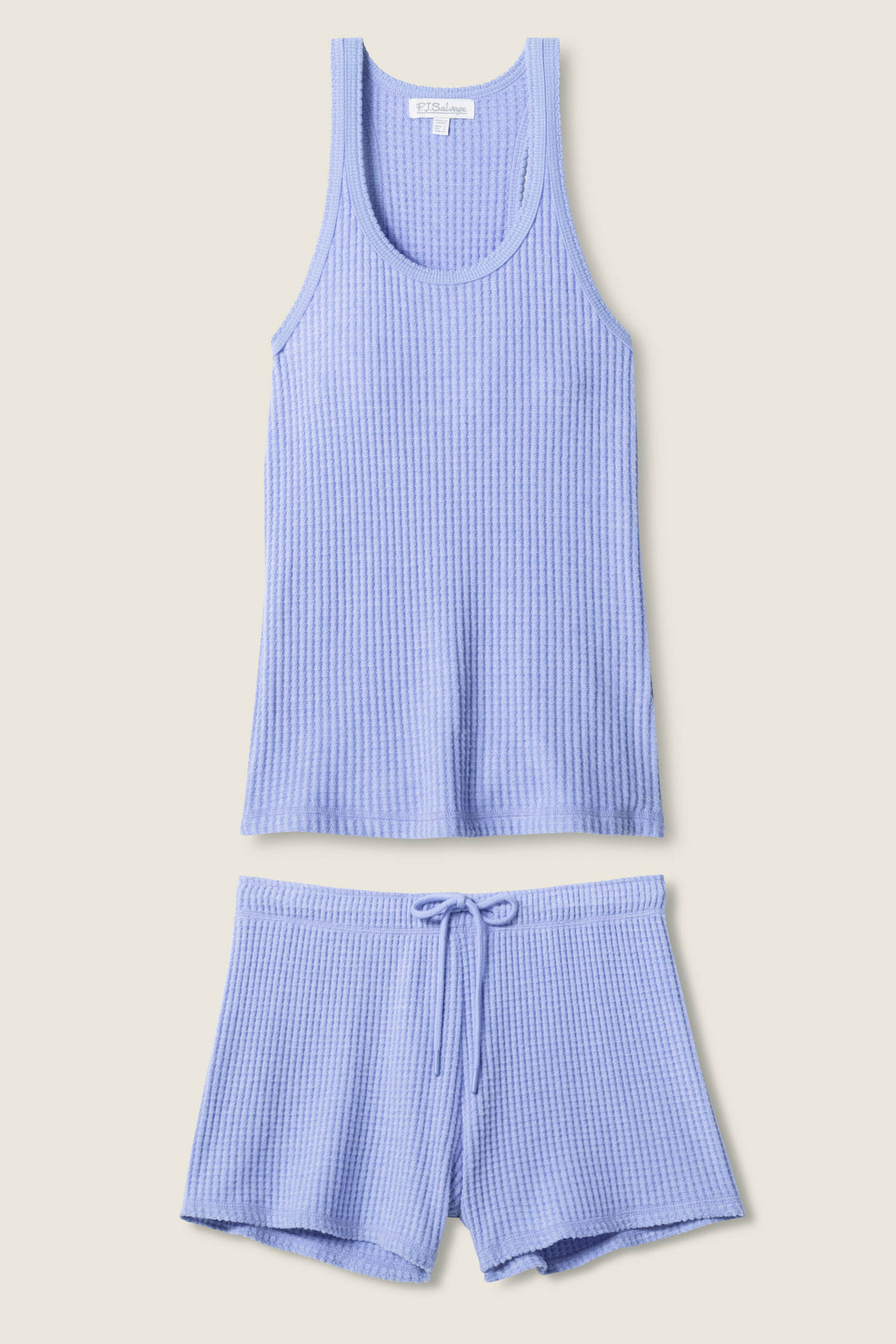 The P.J. Salvage Morning Waffles Peri Loungewear Set, featuring a light purple ribbed thermal tank and shorts, is laid flat on a neutral background, showcasing its cozy and soft textured fabric.