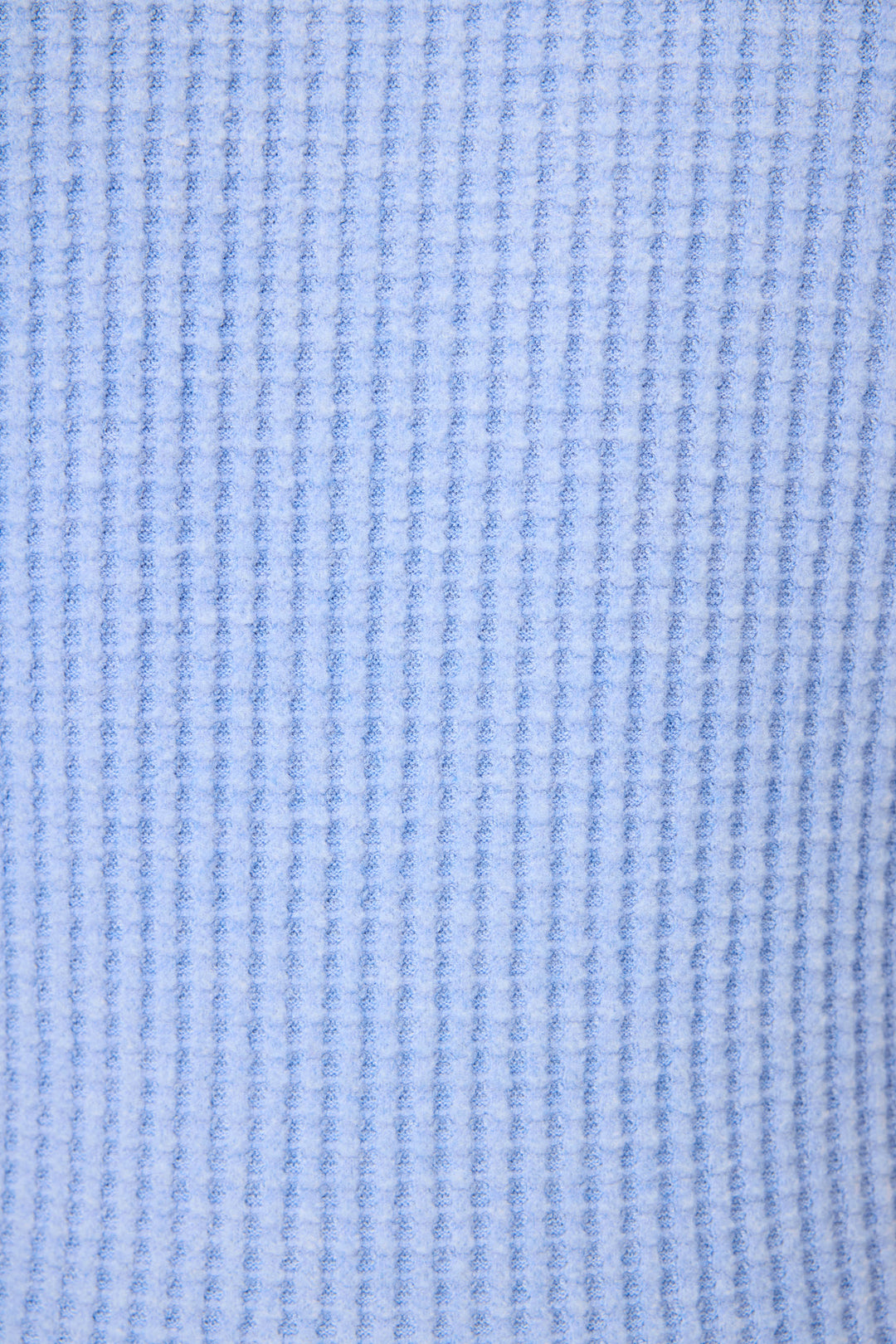 Close-up of the soft, light blue waffle knit fabric from the P.J. Salvage Morning Waffles Peri Loungewear Set, featuring a vertical textured pattern—perfect for cozy loungewear like this tank and shorts set.