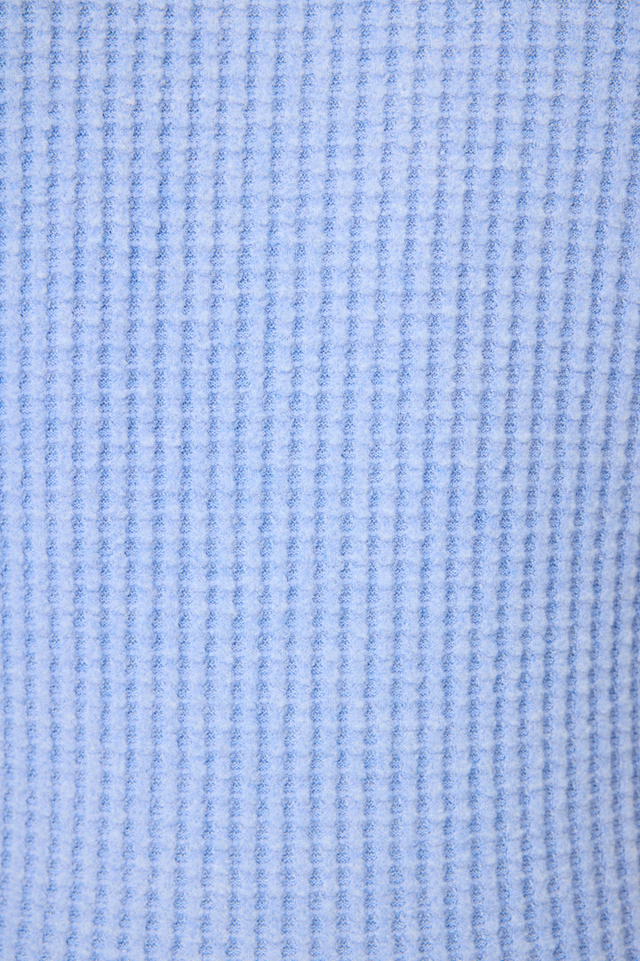 Close-up of the soft, light blue waffle knit fabric from the P.J. Salvage Morning Waffles Peri Loungewear Set, featuring a vertical textured pattern—perfect for cozy loungewear like this tank and shorts set.