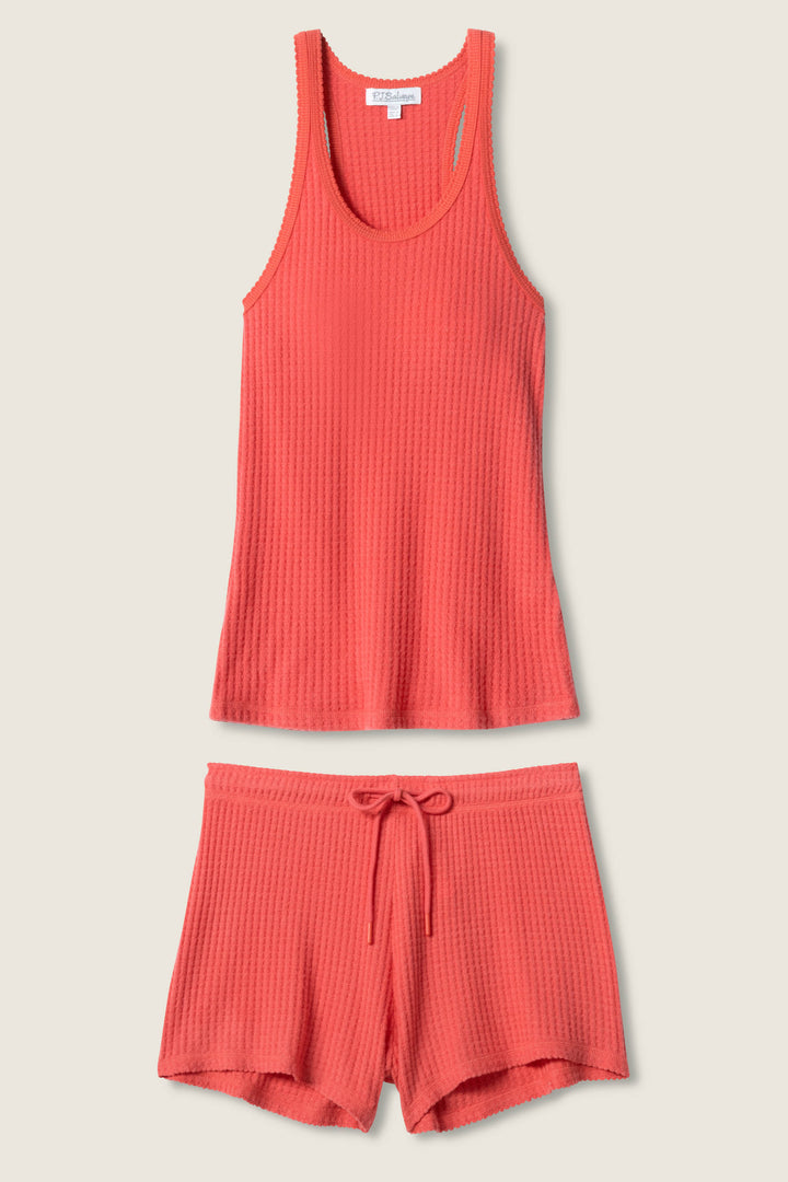 The P.J. Salvage Morning Waffles Scarlet Loungewear Set, featuring a sleeveless scoop neck tank and elastic drawstring shorts, is displayed on a neutral background—perfect cozy loungewear for relaxing in style.