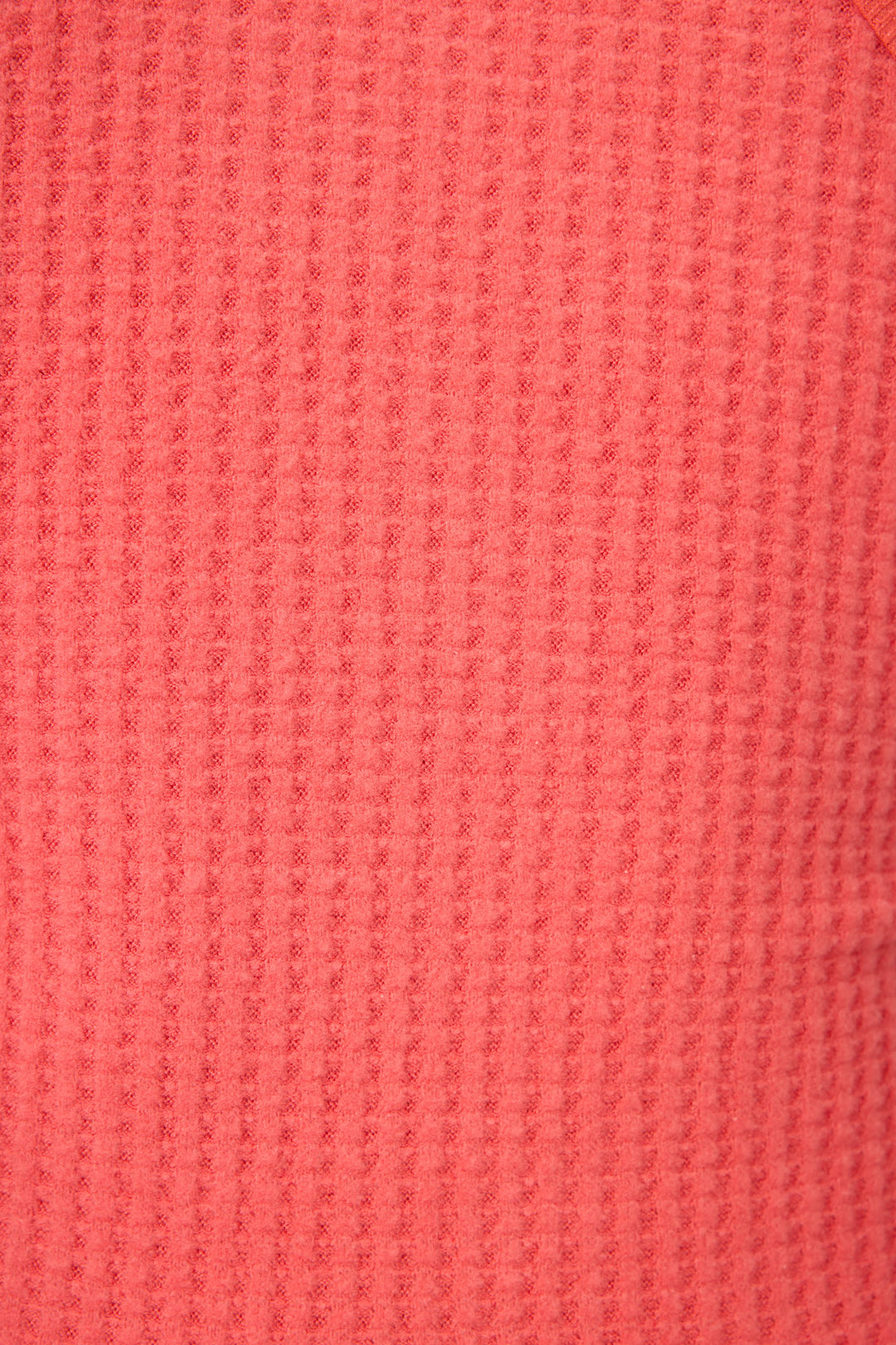 Close-up of the textured coral pink waffle knit fabric from P.J. Salvage’s Morning Waffles Scarlet Loungewear Set, displaying a regular grid pattern with raised and recessed areas.