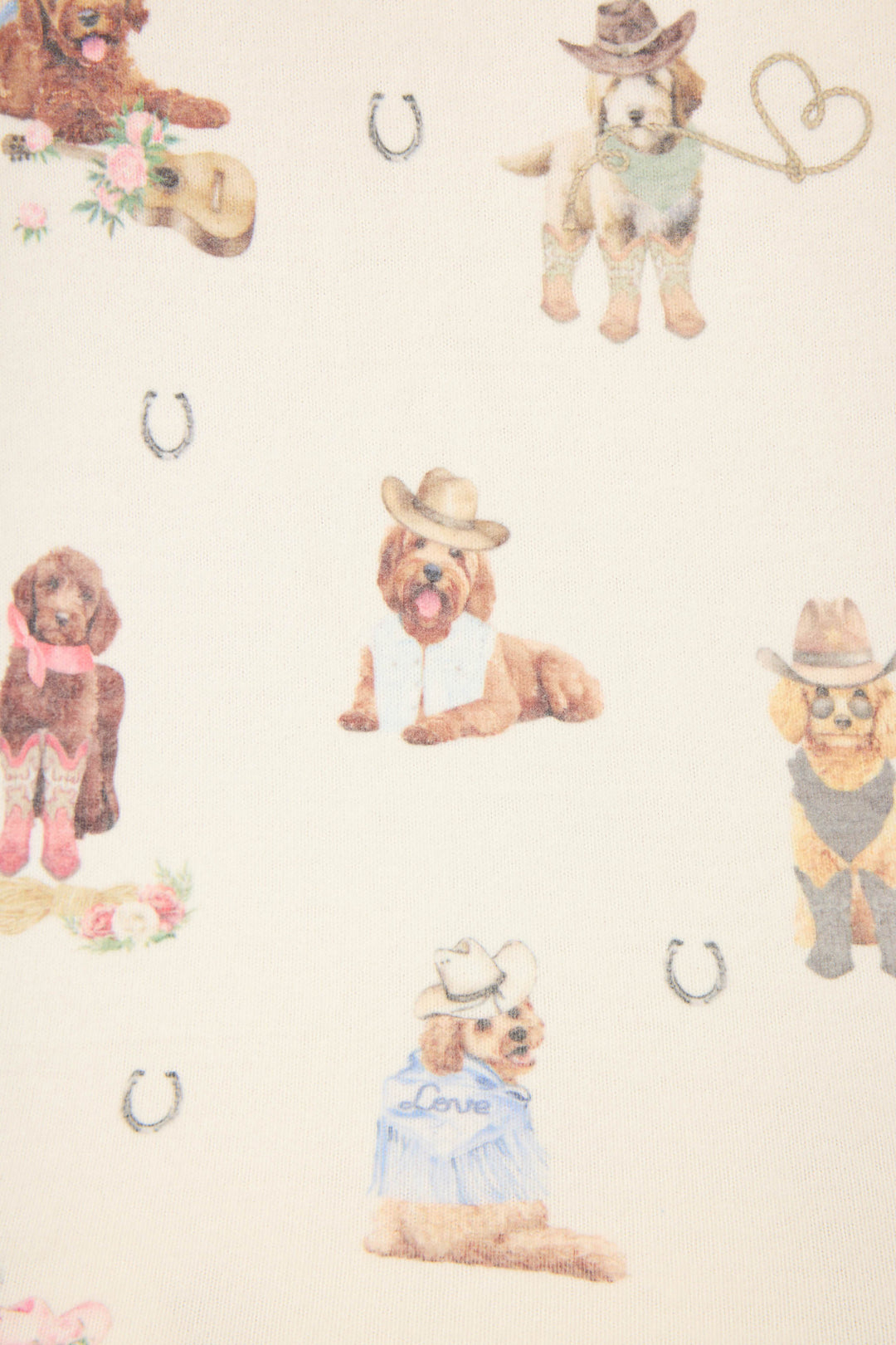 The P.J. Salvage DOGS SHORT RUFF ON THE RANGE features playful illustrations of dogs in cowboy hats and western outfits, sitting and standing among scattered horseshoe icons on a light background.