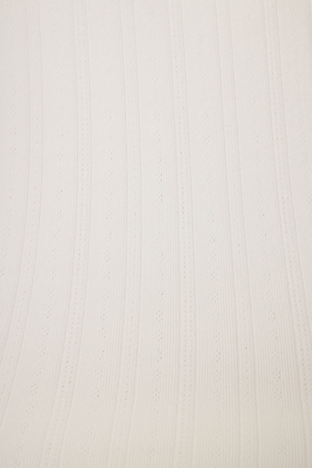 Close-up of the Pointelle Essentials Solid Ivory Camisole by P.J. Salvage, showcasing light beige fabric with vertical ribbed texture and alternating solid and perforated stripes running parallel.