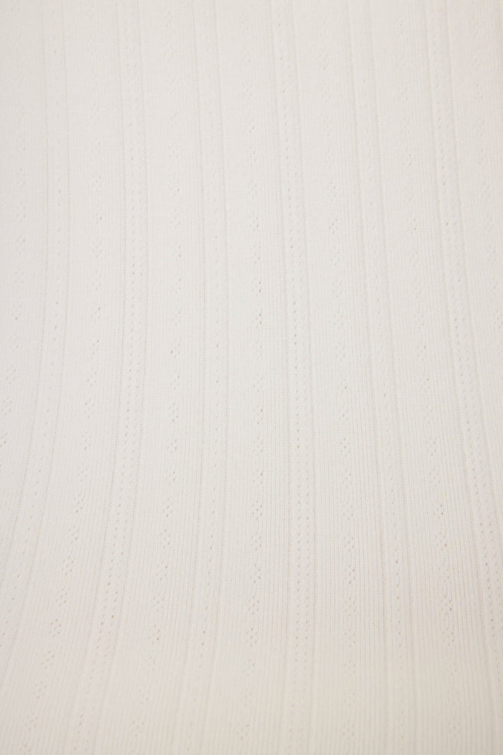 Close-up of the Pointelle Essentials Solid Ivory Camisole by P.J. Salvage, showcasing light beige fabric with vertical ribbed texture and alternating solid and perforated stripes running parallel.