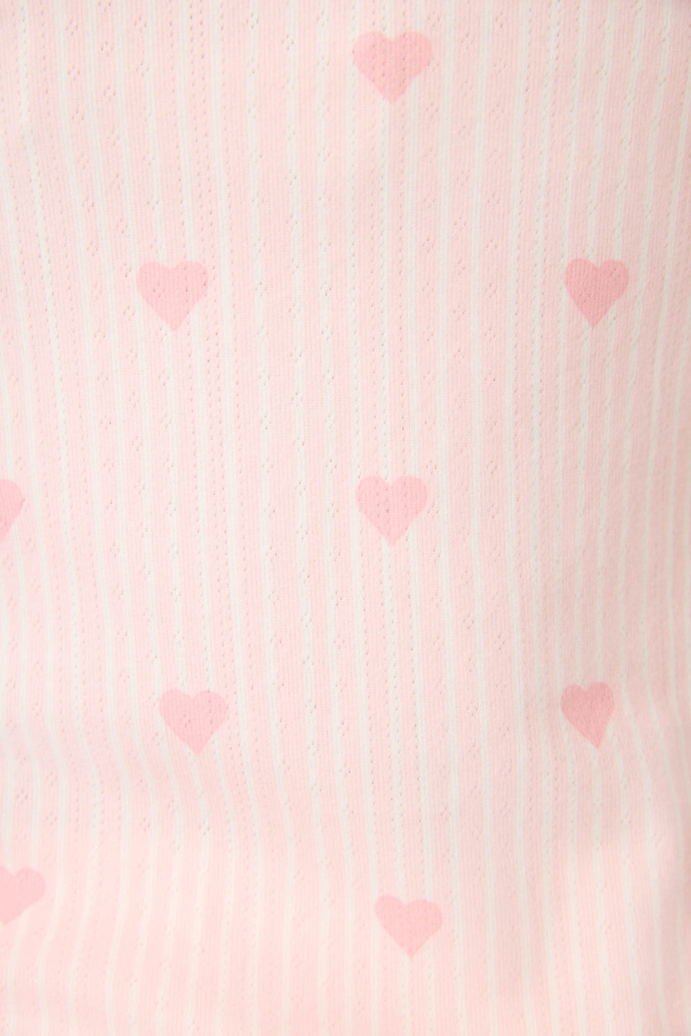 Close-up of the Pointelle Essentials Ditsy Heart 4-Piece Loungewear Set by P.J. Salvage, featuring pink and white vertical stripes with a pattern of evenly spaced small pink hearts on fabric.