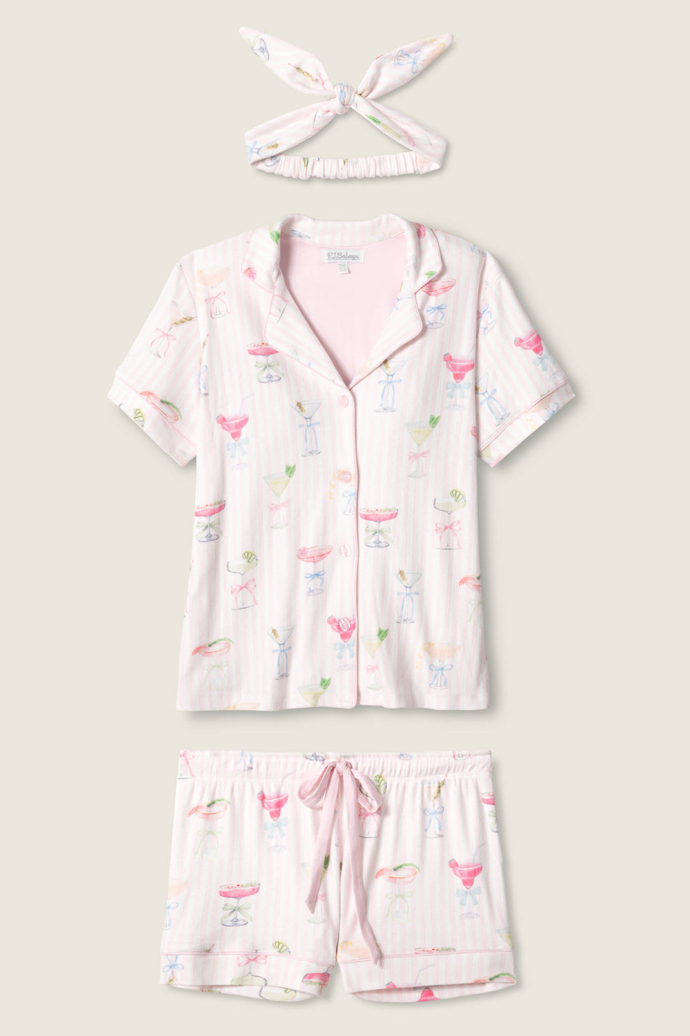 The P.J. Salvage Pretty Punch Cocktail Print 3-Piece Short Set features a short-sleeve button-up top, drawstring shorts, and a matching headband in light pink with colorful cocktail-themed prints.