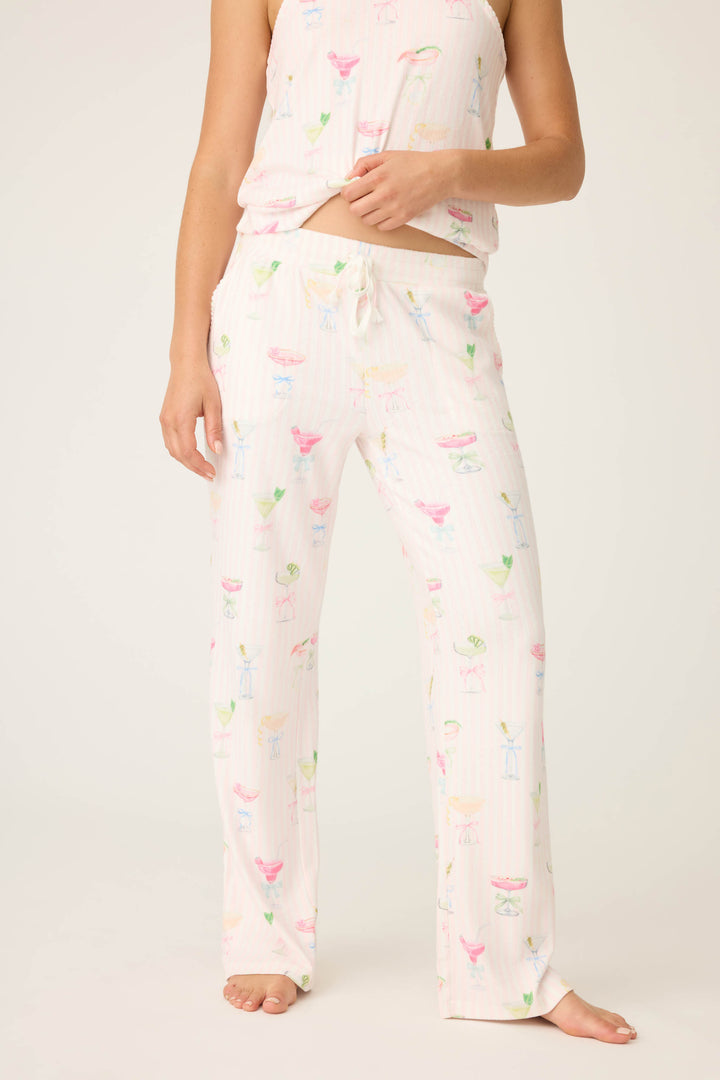 A person stands barefoot in P.J. Salvage Pretty Punch Cocktail Print Open Leg Pants with a matching sleeveless top; their face is not visible.