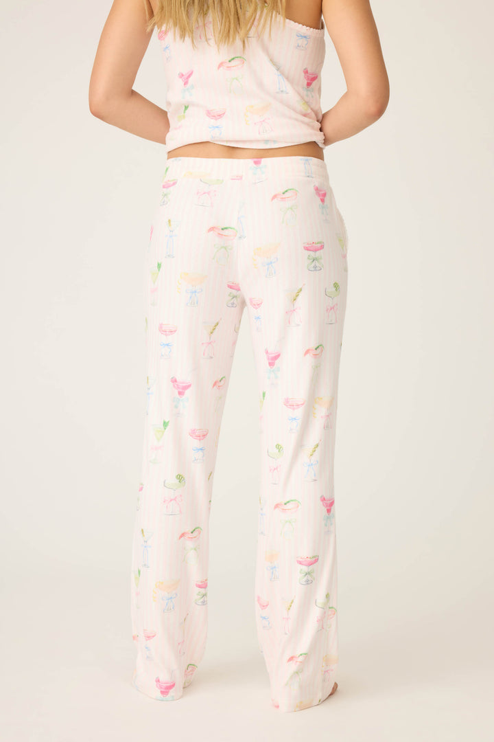 A person wearing P.J. Salvages Pretty Punch Cocktail Print Open Leg Pants stands with their back to the camera, showcasing the colorful, playful pattern against a plain background.