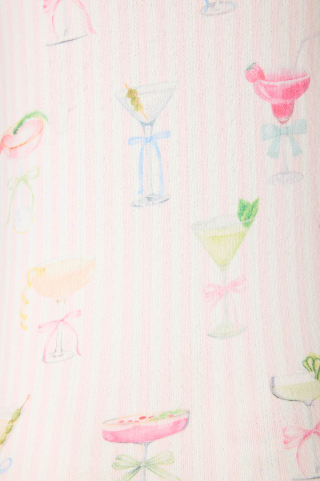 A close-up of the Pretty Punch Cocktail Print Racerback Tank Top by P.J. Salvage, featuring pastel cocktail glasses with fruit and ribbons on a pale pink and white striped fabric.