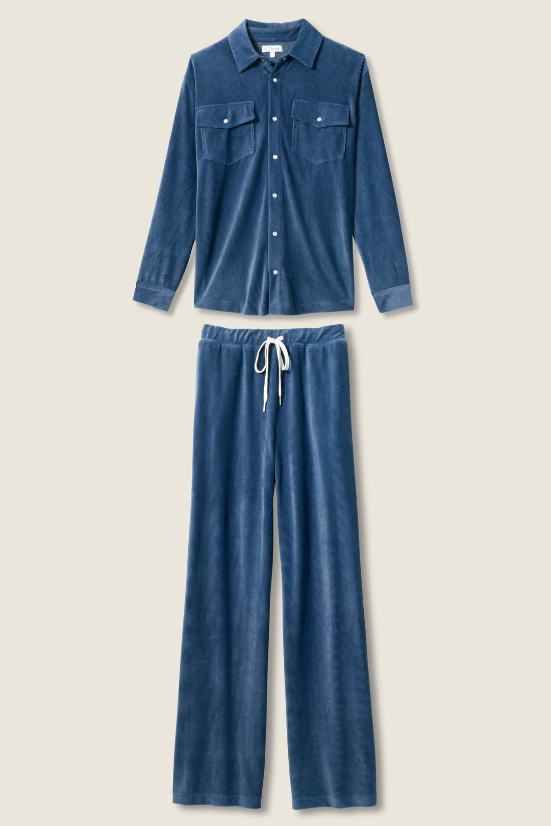 The Craving Corduroy Velour Lounge Set by P.J. Salvage, in blue, features a retro button-up shirt with two chest pockets and matching wide-leg drawstring pants, both shown laid flat on a neutral background.
