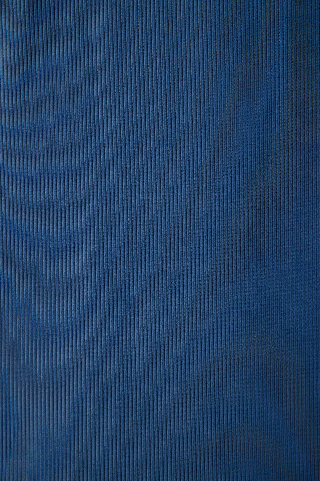 Close-up of the Craving Corduroy Velour Lounge Set by P.J. Salvage highlights its blue velour fabric with vertical ridges and a soft, textured surface, featuring even color and a consistent ribbed pattern throughout.