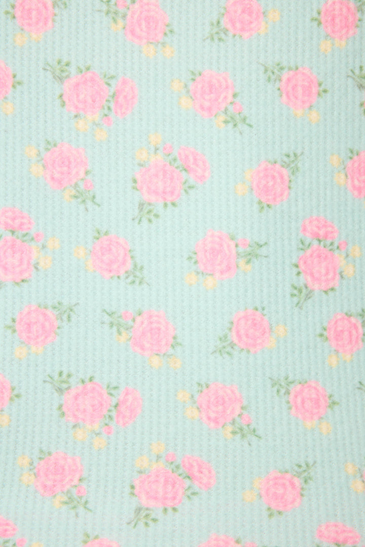 The Secret Garden Floral Camisole by P.J. Salvage showcases light blue textured fabric with a repeating pattern of pink roses, green leaves, and yellow accents.