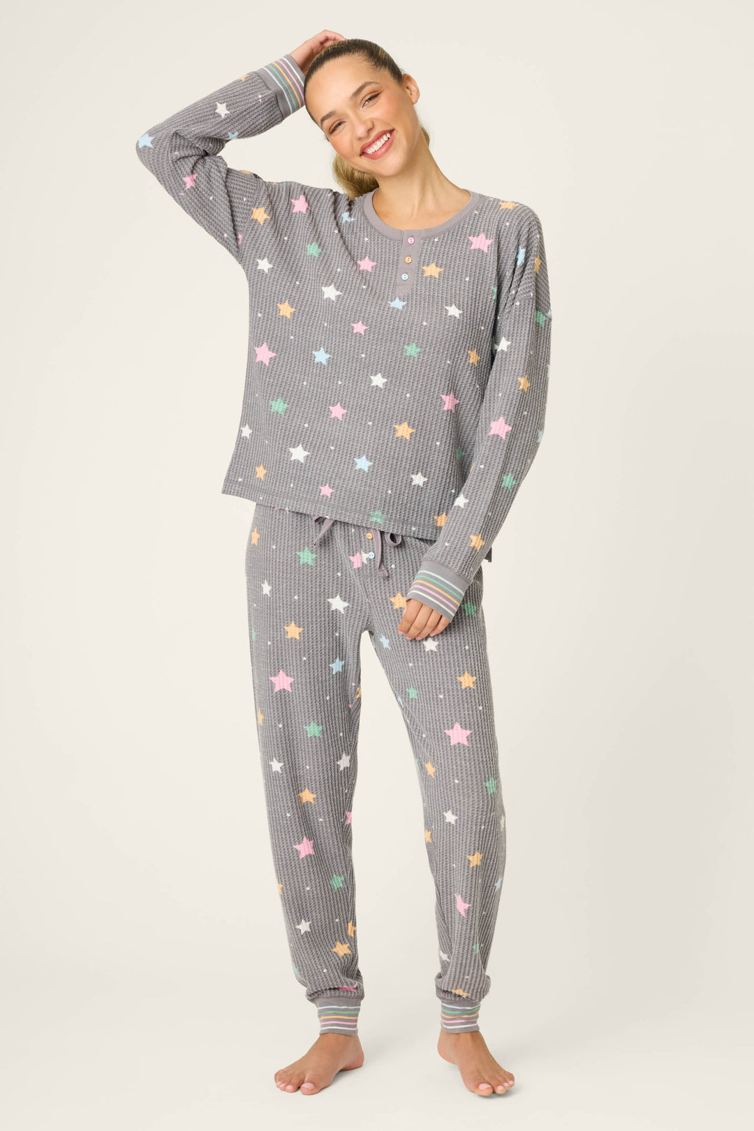 A woman wearing the P.J. Salvage Ski Jammie Classics Star Print PJ Set poses for the camera.