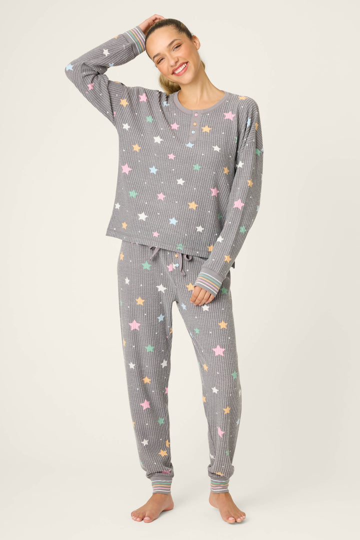 A woman wearing the P.J. Salvage Ski Jammie Classics Star Print PJ Set poses for the camera.