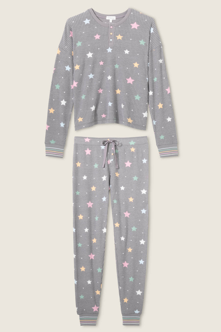 The Ski Jammie Classics Star Print PJ Set by P.J. Salvage features a gray ribbed long-sleeve top and pants with pastel star print, striped cuffs, and drawstring waist for cozy style.
