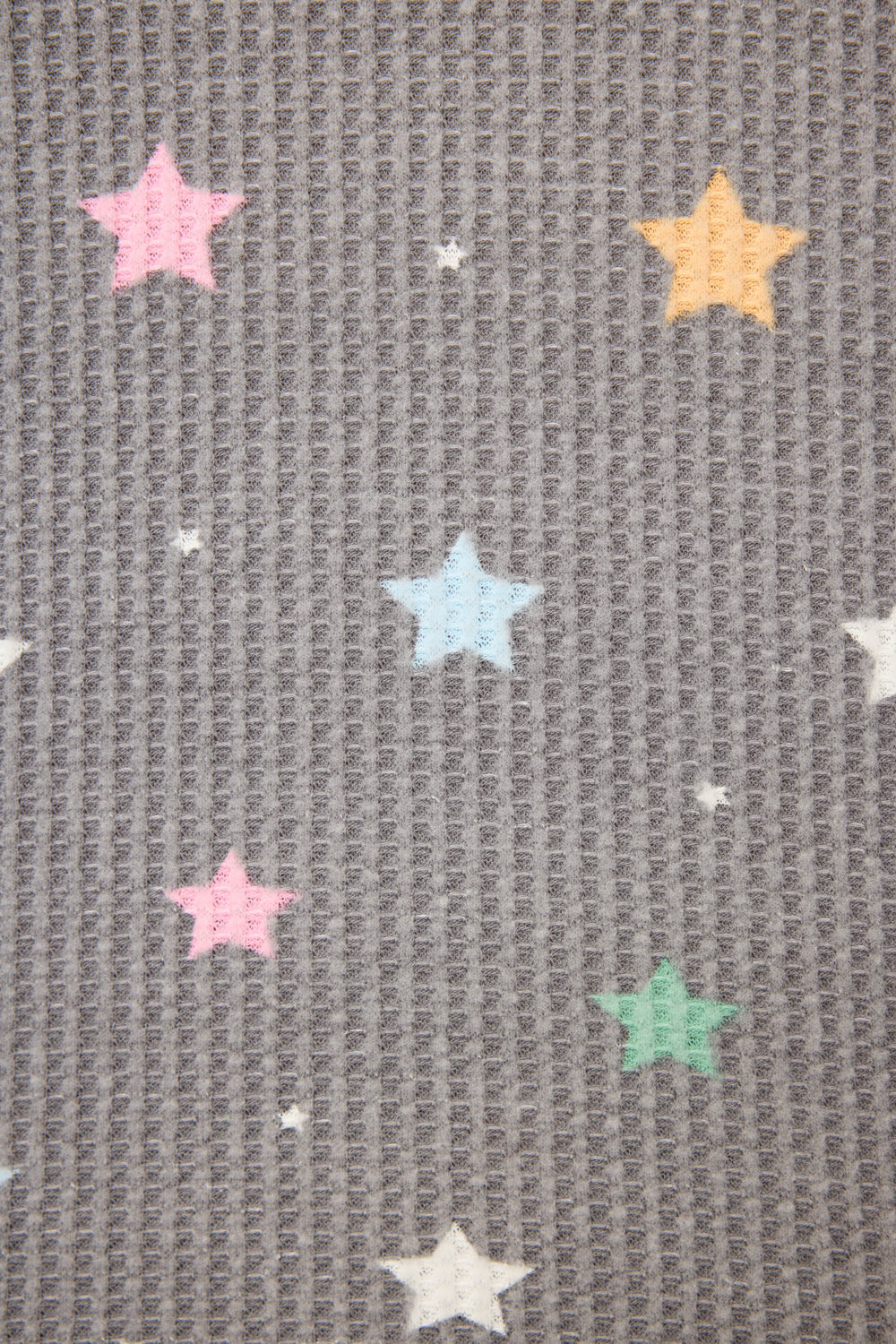 The P.J. Salvage Ski Jammie Classics Star Print PJ Set features textured gray fabric adorned with pastel stars in pink, yellow, blue, green, and white, plus scattered small white dots.
