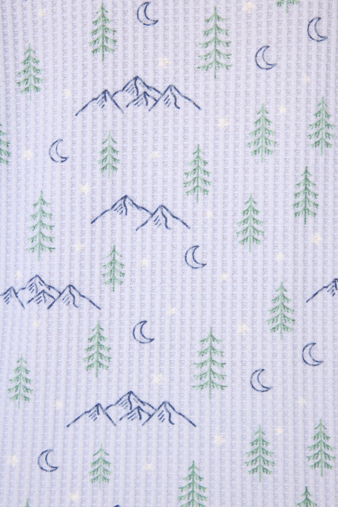 The P.J. Salvage Ski Jammie Classics Winter Tree Print PJ Set features a repeating pattern of blue mountains, green pine trees, crescent moons, and yellow stars on a white textured background.