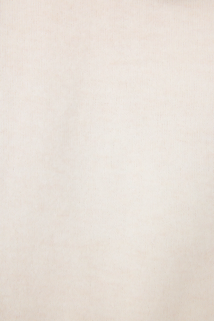Close-up of The Outsider Fleece Graphic Hoodie by P.J. Salvage in beige, featuring a subtle texture and visible weave pattern. The fabric appears smooth and even with minimal color variation.