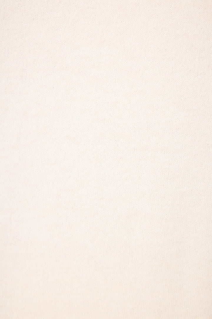 A close-up view of the light beige fabric of P.J. Salvage’s The Outsider Graphic Jogger Lounge Set, featuring a subtle woven texture with no visible patterns or markings.