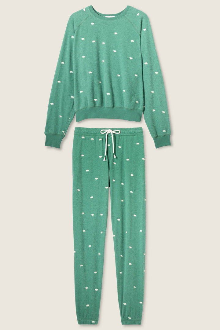 The Outsider Embroidered Bear Fleece Lounge Set by P.J. Salvage features a green long-sleeve crewneck top and drawstring pants, both adorned with small white dotted patterns throughout.