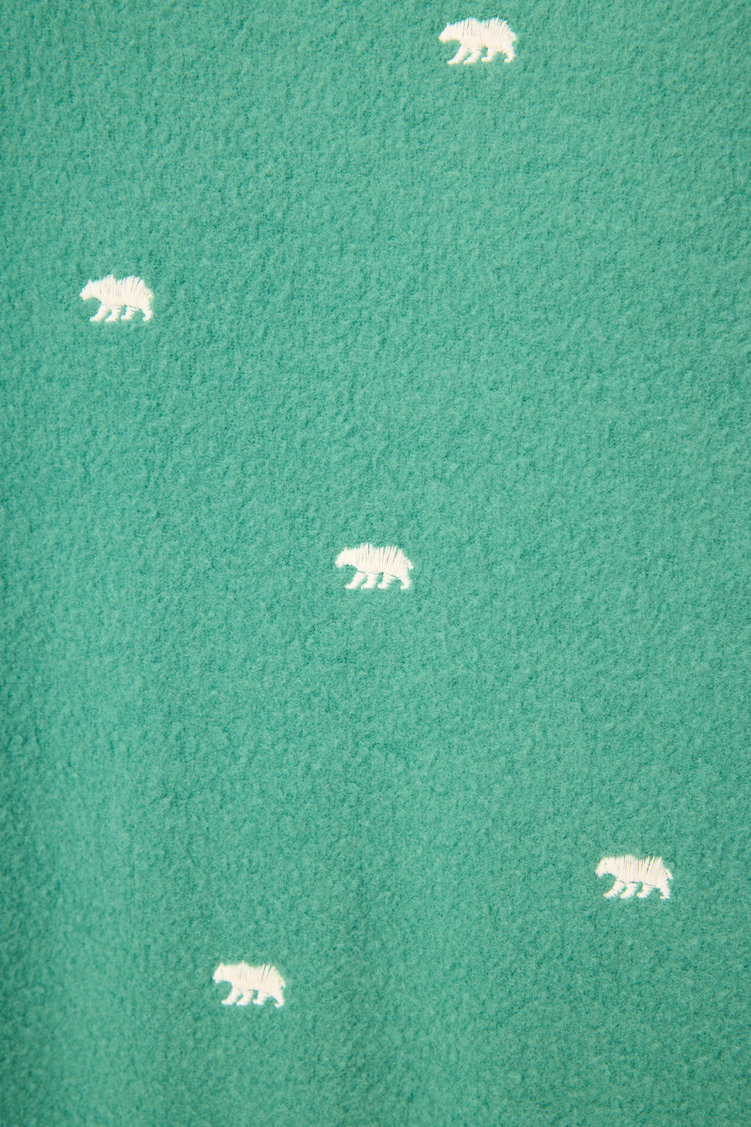 The Outsider Embroidered Bear Fleece Lounge Set by P.J. Salvage features green textured fabric adorned with evenly spaced, small white bear silhouettes.
