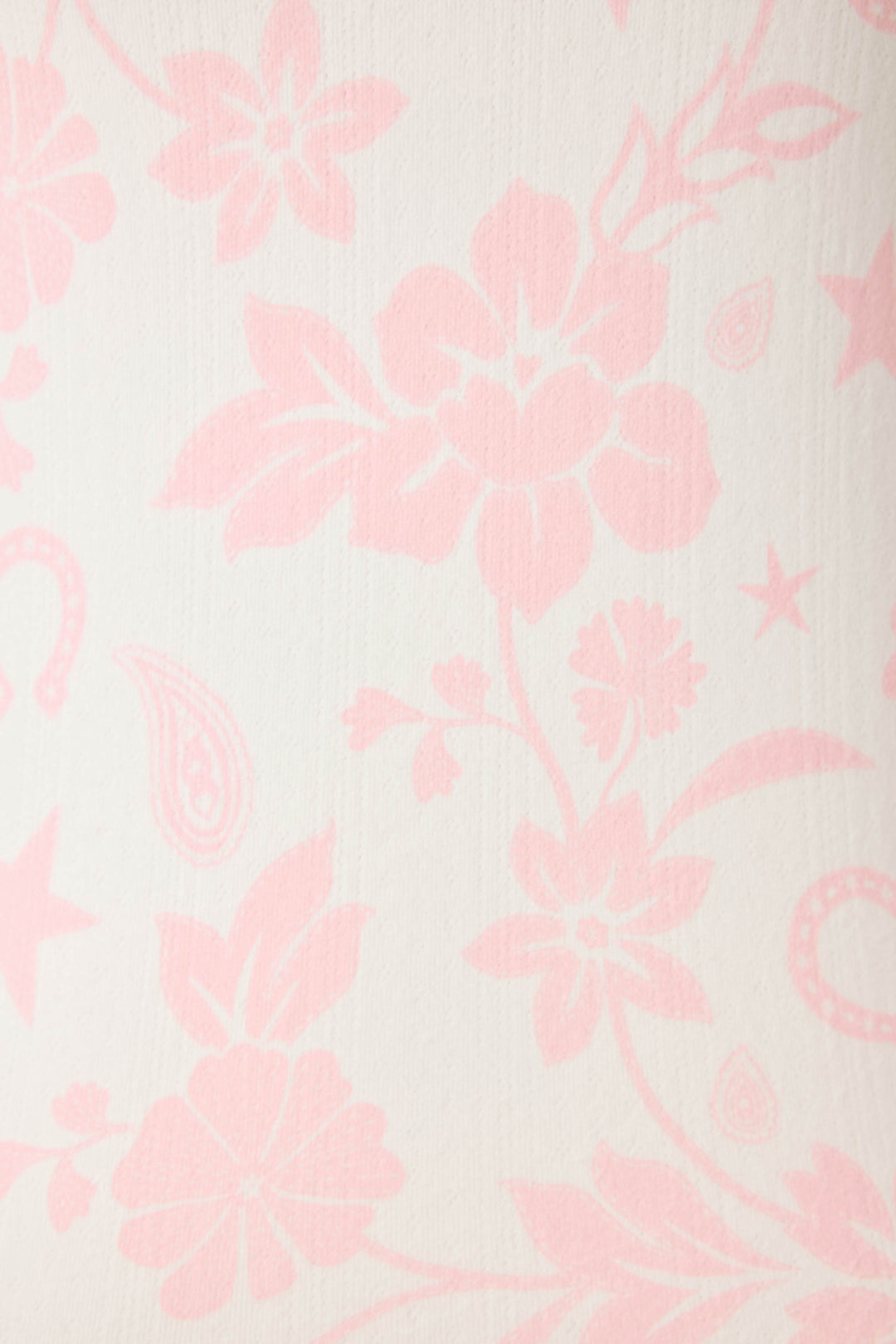 The Wild Flower Western Floral Print Open Leg Pants by P.J. Salvage feature a cream-colored fabric with a light pink floral and paisley pattern, showcasing large flowers, leaves, and decorative shapes throughout.