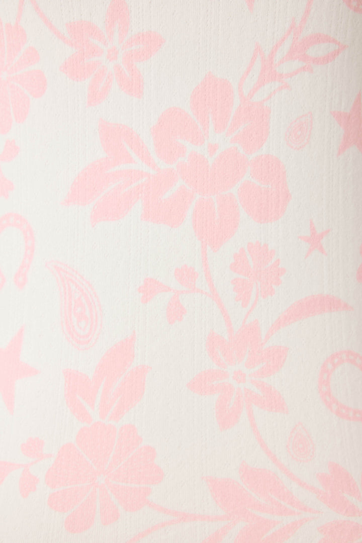 The Wild Flower Western Floral Print Open Leg Pants by P.J. Salvage feature a cream-colored fabric with a light pink floral and paisley pattern, showcasing large flowers, leaves, and decorative shapes throughout.
