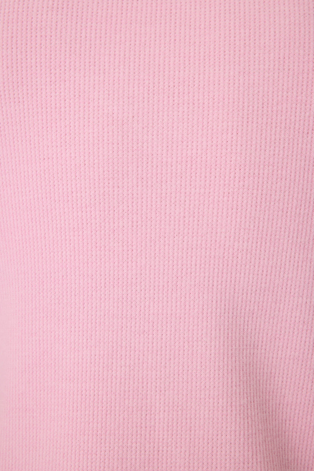 Close-up of the Wish You Were Here Peachy Short Sleeve Top by P.J. Salvage, featuring soft, smooth pink ribbed fabric with evenly spaced vertical textured lines.