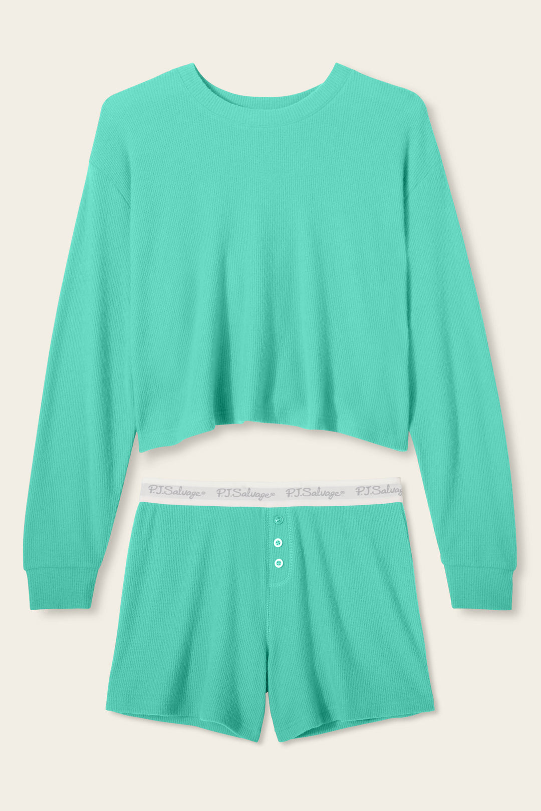 The Boyfriend Boxer Solid Green Short Set by P.J. Salvage features a ribbed, soft material with a long-sleeve cropped top and high-waisted shorts, accented by white buttons and an elastic waistband with repeated text.