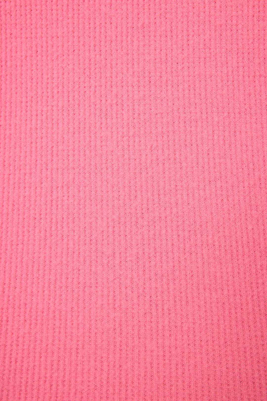 Close-up of the P.J. Salvage Boyfriend Boxer Solid Pink Short Set shows its pink ribbed fabric with vertical lines and a soft, slightly fuzzy texture.