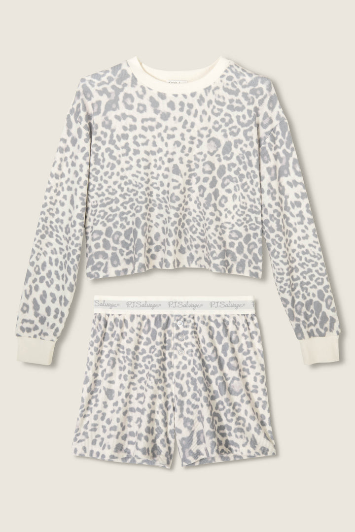 The Boyfriend Boxer Leopard Print Shorts Set by P.J. Salvage features a long-sleeve top and shorts in a white and gray leopard print with ribbed cuffs and waistband, displayed flat on a light beige background.