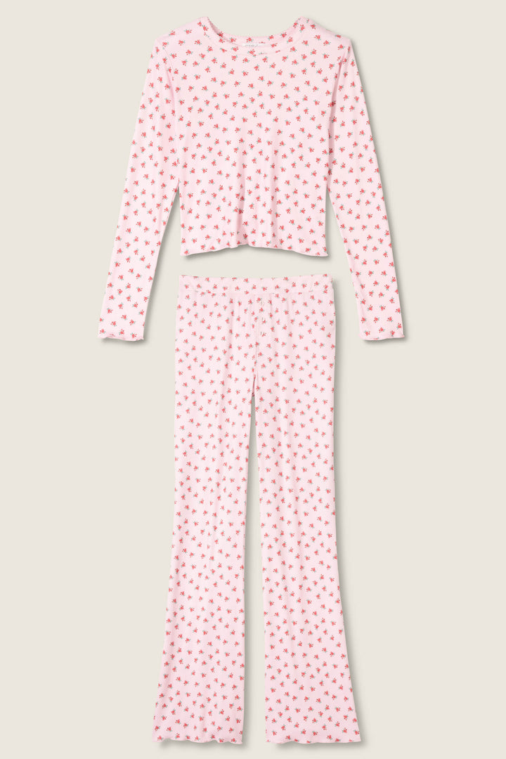 The Crazy For The Holidays Ditsy Floral Print Pants Set by P.J. Salvage features a girls' long-sleeve, cropped pink pointelle top and full-length pants with a ditsy floral print, displayed flat on a light background.