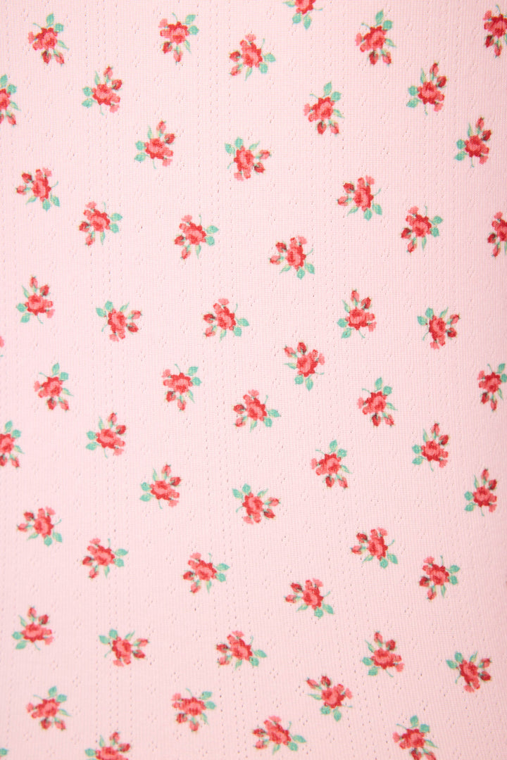 The Crazy For The Holidays Ditsy Floral Print Pants Set by P.J. Salvage features a pink pointelle fabric with evenly spaced red and green ditsy floral clusters, giving these girls' holiday pajamas a festive and decorative look.