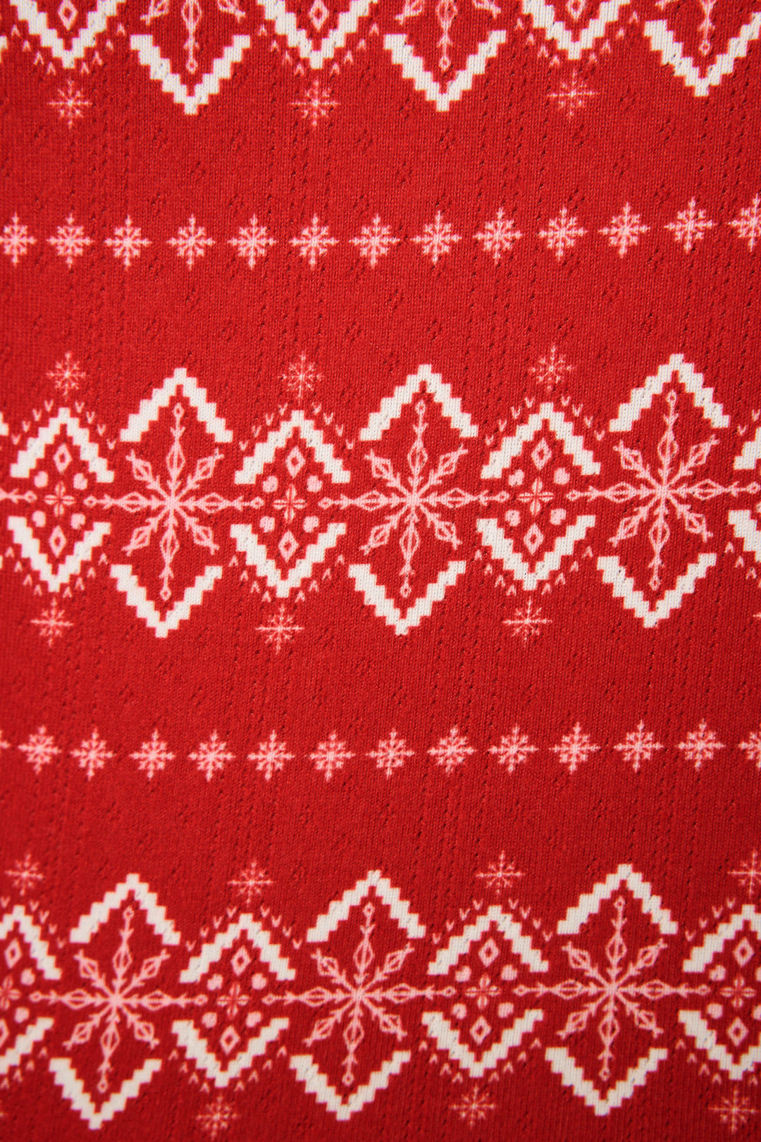 The Crazy For The Holidays Fairisle Print Pants Set by P.J. Salvage features red fabric with a white Fair Isle snowflake pattern in horizontal rows, evoking classic winter style for cozy holiday pajamas.