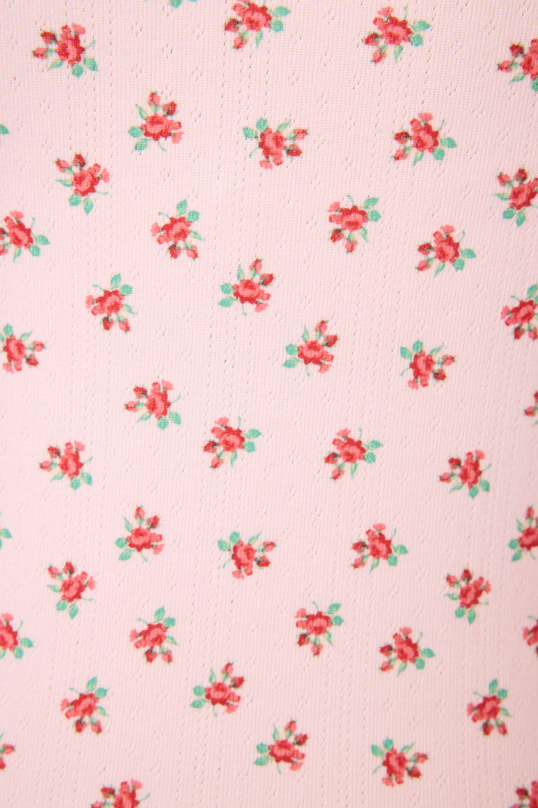 The Crazy For The Holidays Ditsy Floral Print Tank Top by P.J. Salvage features a pale pink fabric adorned with evenly spaced small red and green floral clusters.