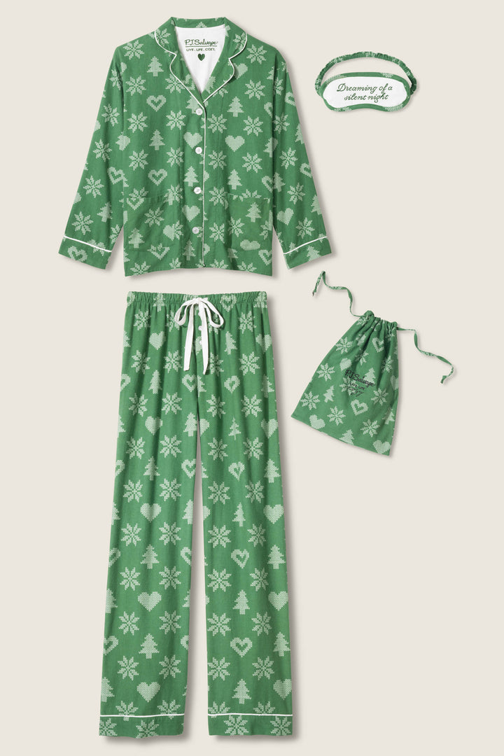 The P.J. Salvage 4-Piece Tree & Heart Print Flannel PJ Set features a green long-sleeve top, drawstring pants, matching pouch, and an eye mask with "Dreaming of adventure" – all with festive white snowflake, heart, and tree prints.
