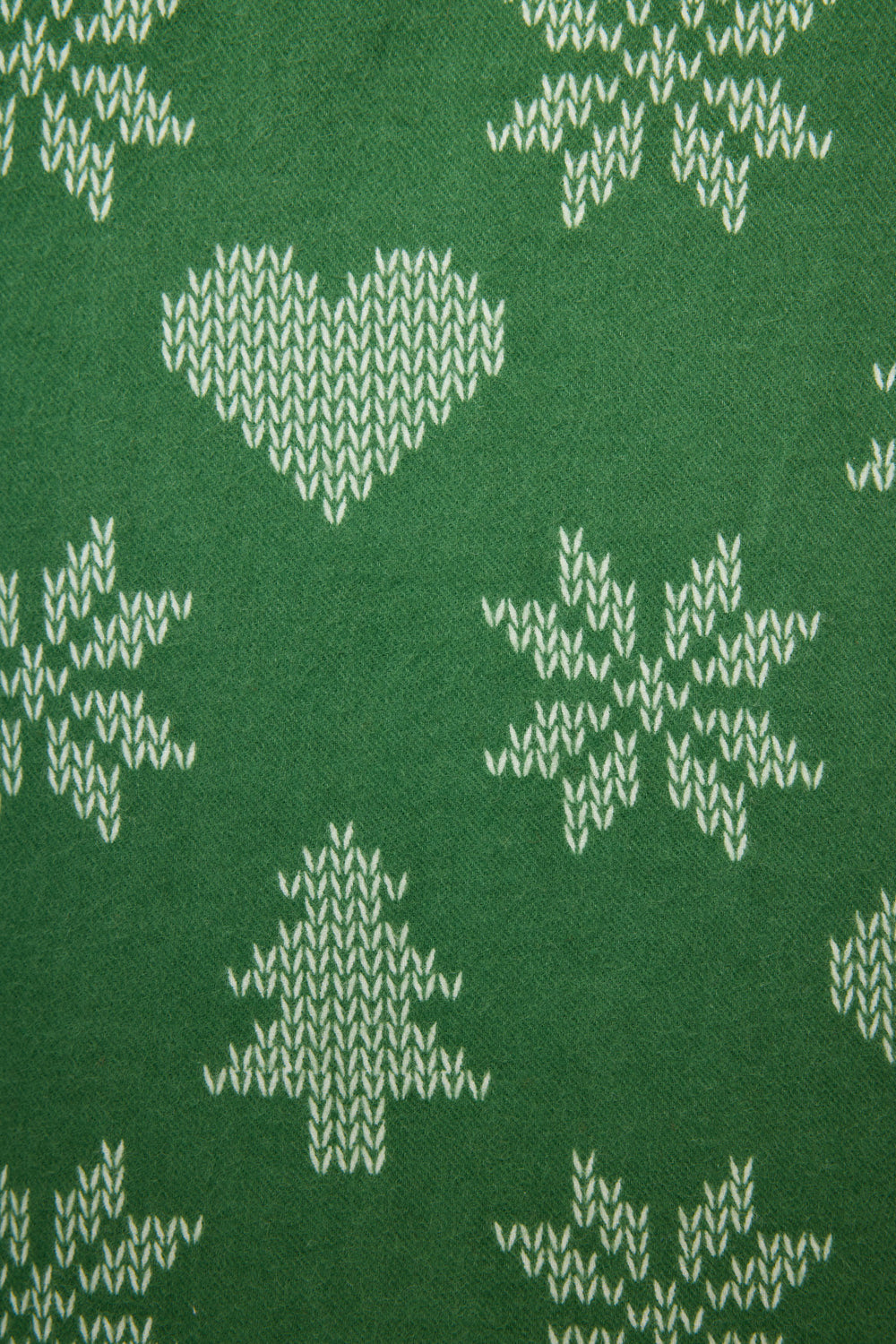 The 4-Piece Tree & Heart Print Flannel PJ Set by P.J. Salvage features green fabric with white heart, pine tree, and snowflake motifs in a festive winter design.